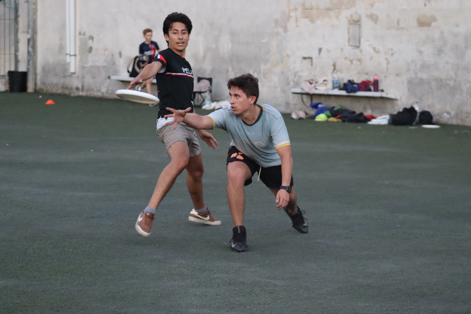 A Mela Ultimate player releasing a pass while a defender marks him at Attard Football Ground