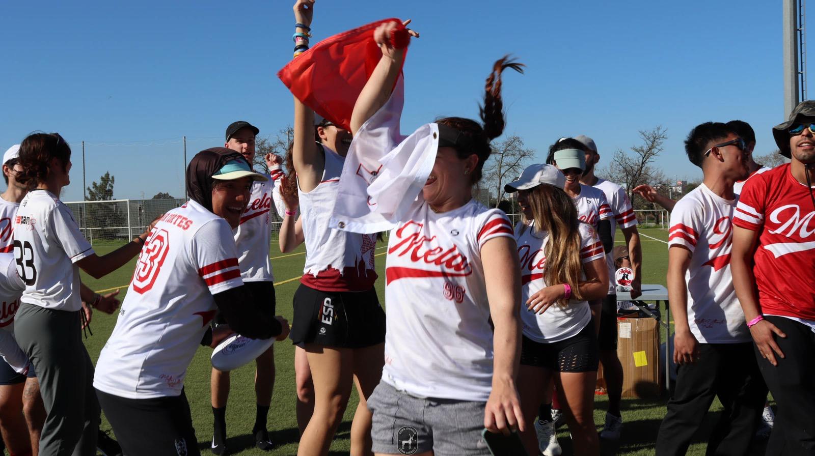 Mela Ultimate players celebrating together on the pitch in club kit