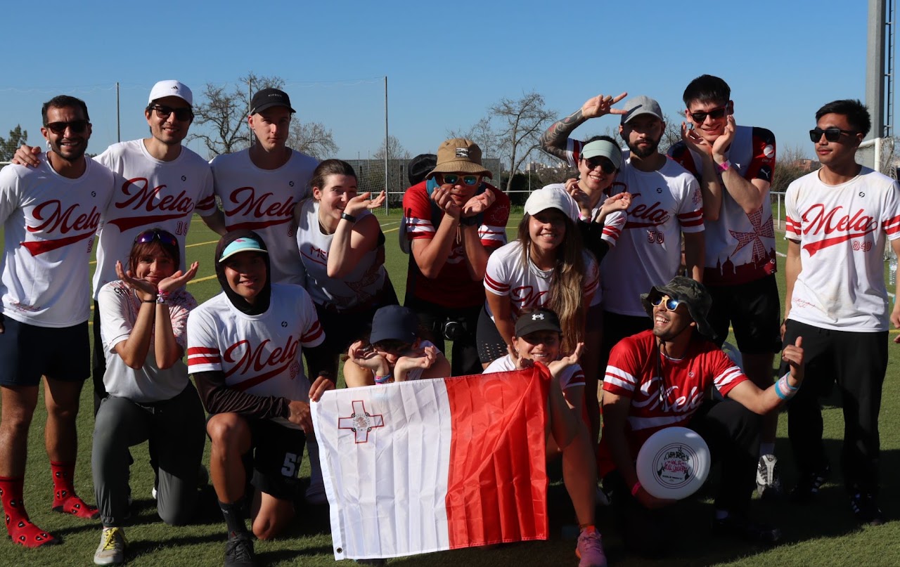 Mela Ultimate squad posing on the pitch with a Malta flag after Copa Ibérica 2026